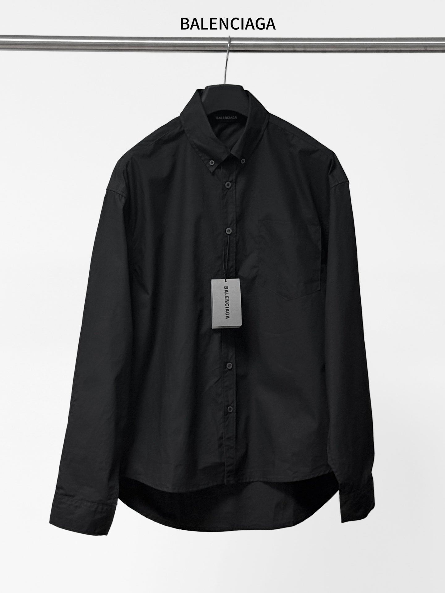 Long-sleeve button-up shirt by Balenciaga, dark black, front view with button placket.