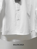 Balenciaga long-sleeve button-up shirt, white, front buttons and lower hem detail.