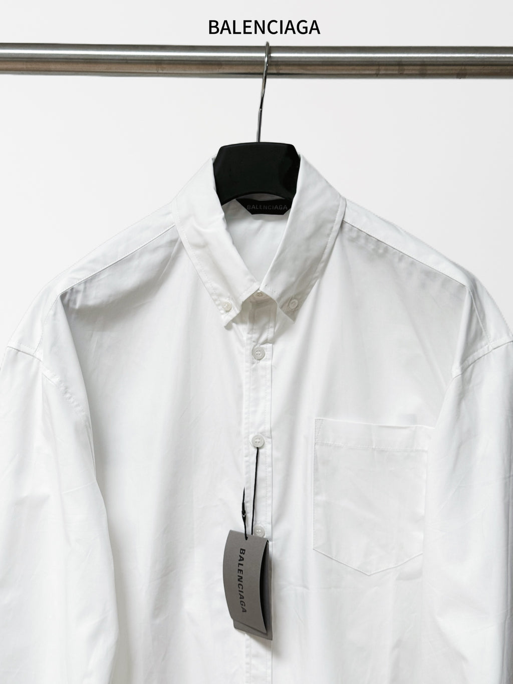 Balenciaga long-sleeve button-up shirt, white, front placket and chest pocket.