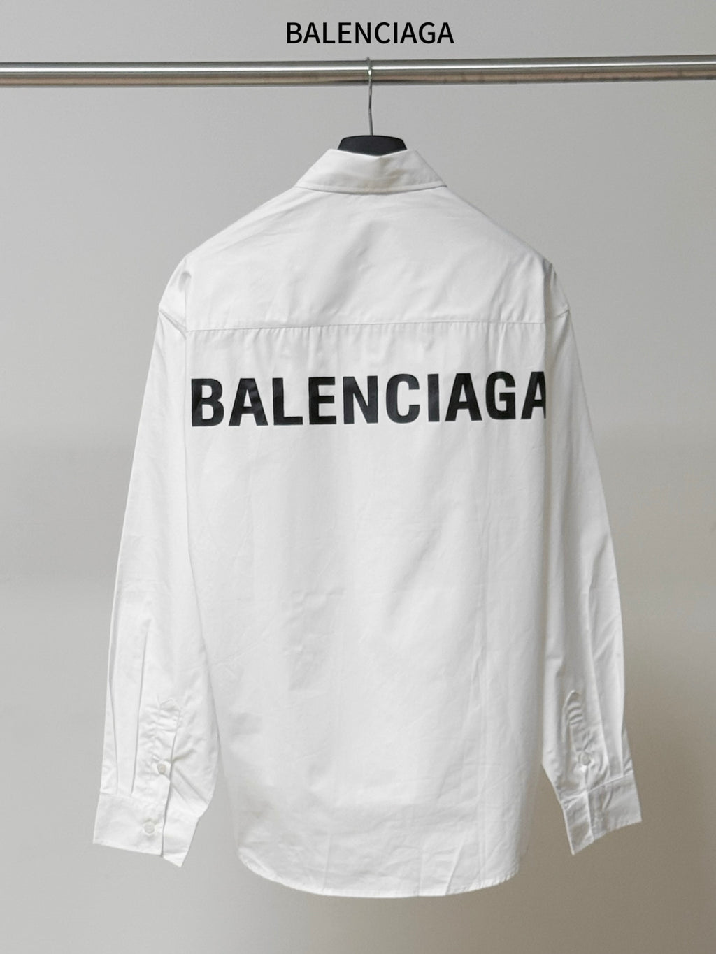 Balenciaga long-sleeve button-up shirt, white, back print, buttoned collar.
