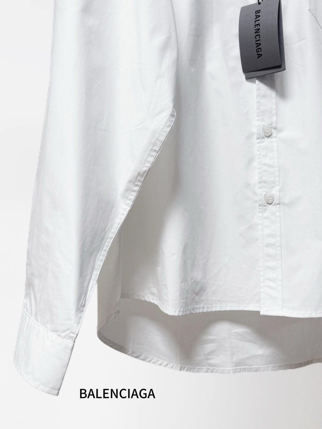 Balenciaga long-sleeve button-up shirt, white, side view with buttoned front.
