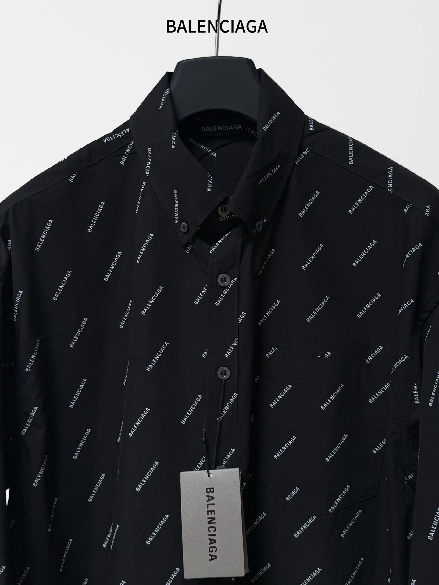 Balenciaga long-sleeve shirt close-up, black logo print, button placket and pointed collar