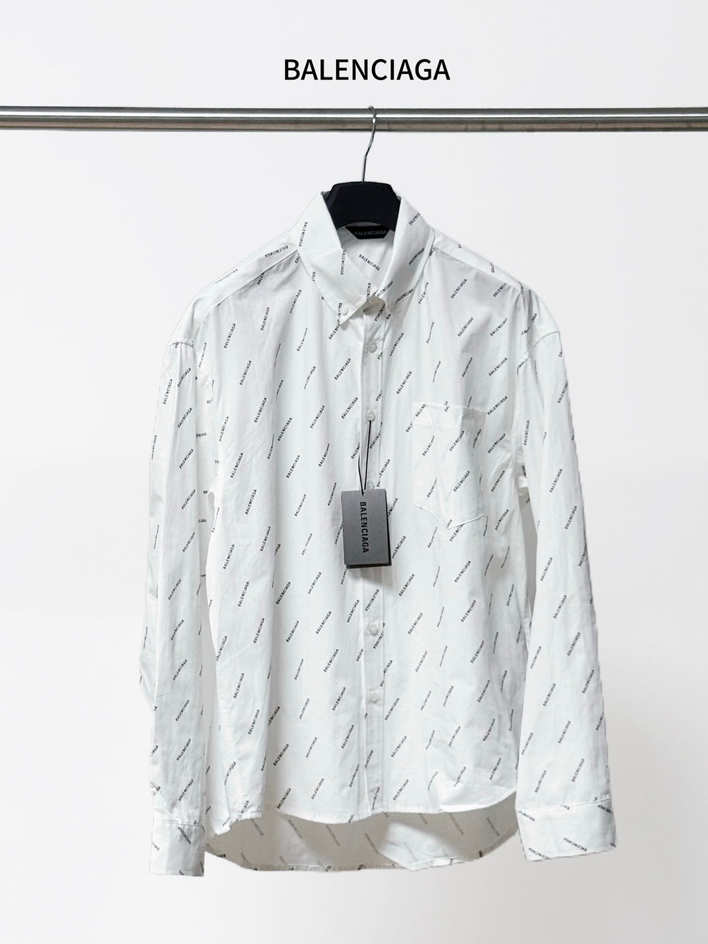 Long-sleeve button-up shirt with allover black logo pattern, pointed collar and front buttons