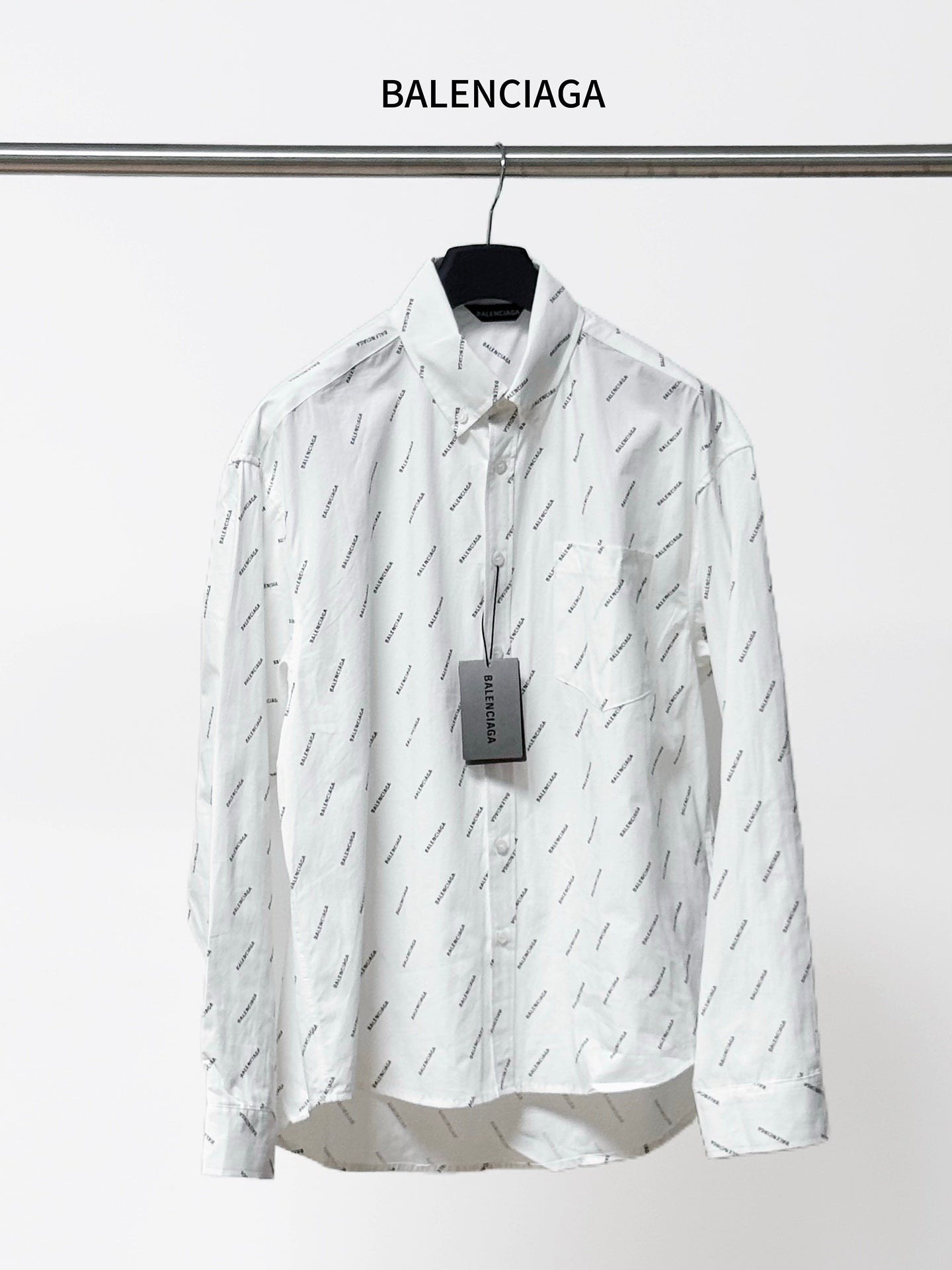 Long-sleeve button-up shirt with allover black logo pattern, pointed collar and front buttons