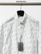 Long-sleeve button-up shirt front view with black logo print and buttoned placket