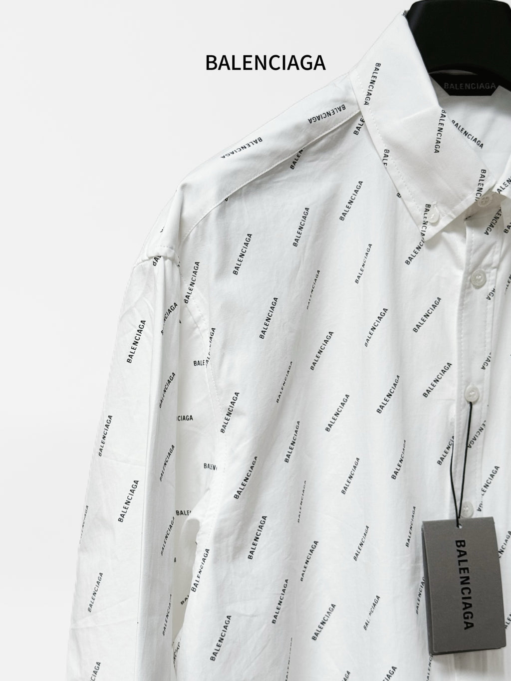 Long-sleeve button-up shirt with black logo pattern, spread collar and chest pocket