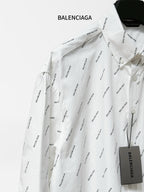 Long-sleeve button-up shirt with black logo pattern, spread collar and chest pocket