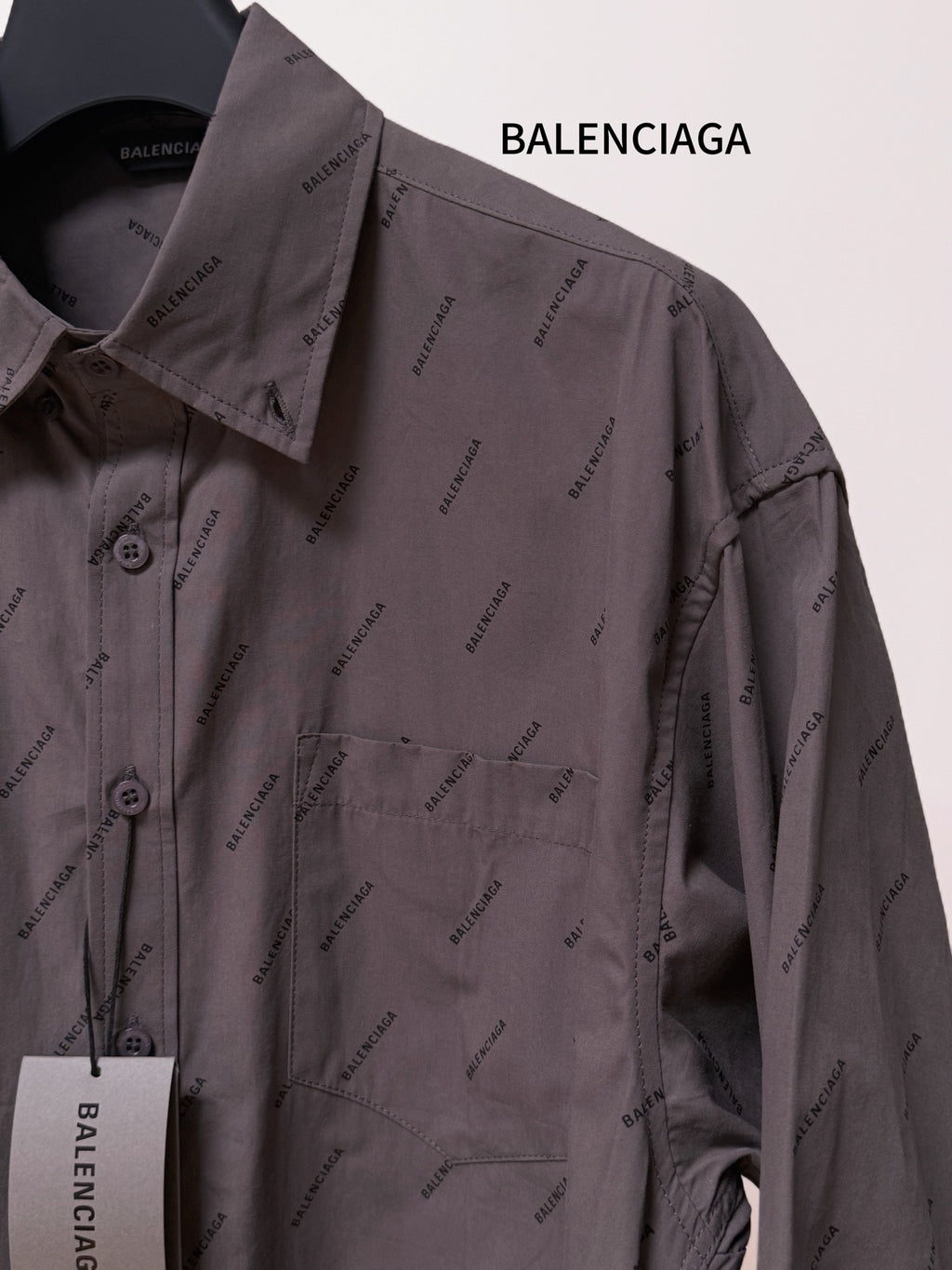 Balenciaga long-sleeve button-up shirt, gray with logo pattern and hanging tag