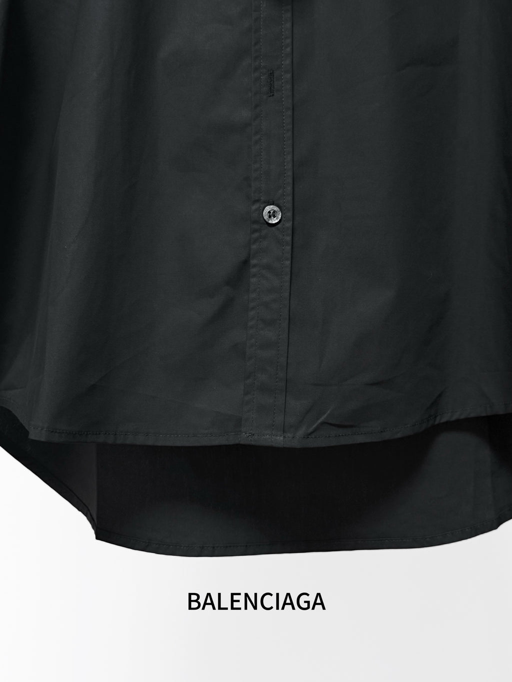 Black shirt front with center button placket and curved hem.