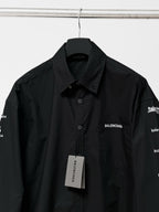 Black long-sleeve button-up shirt with Balenciaga chest logo, collar, and hangtag