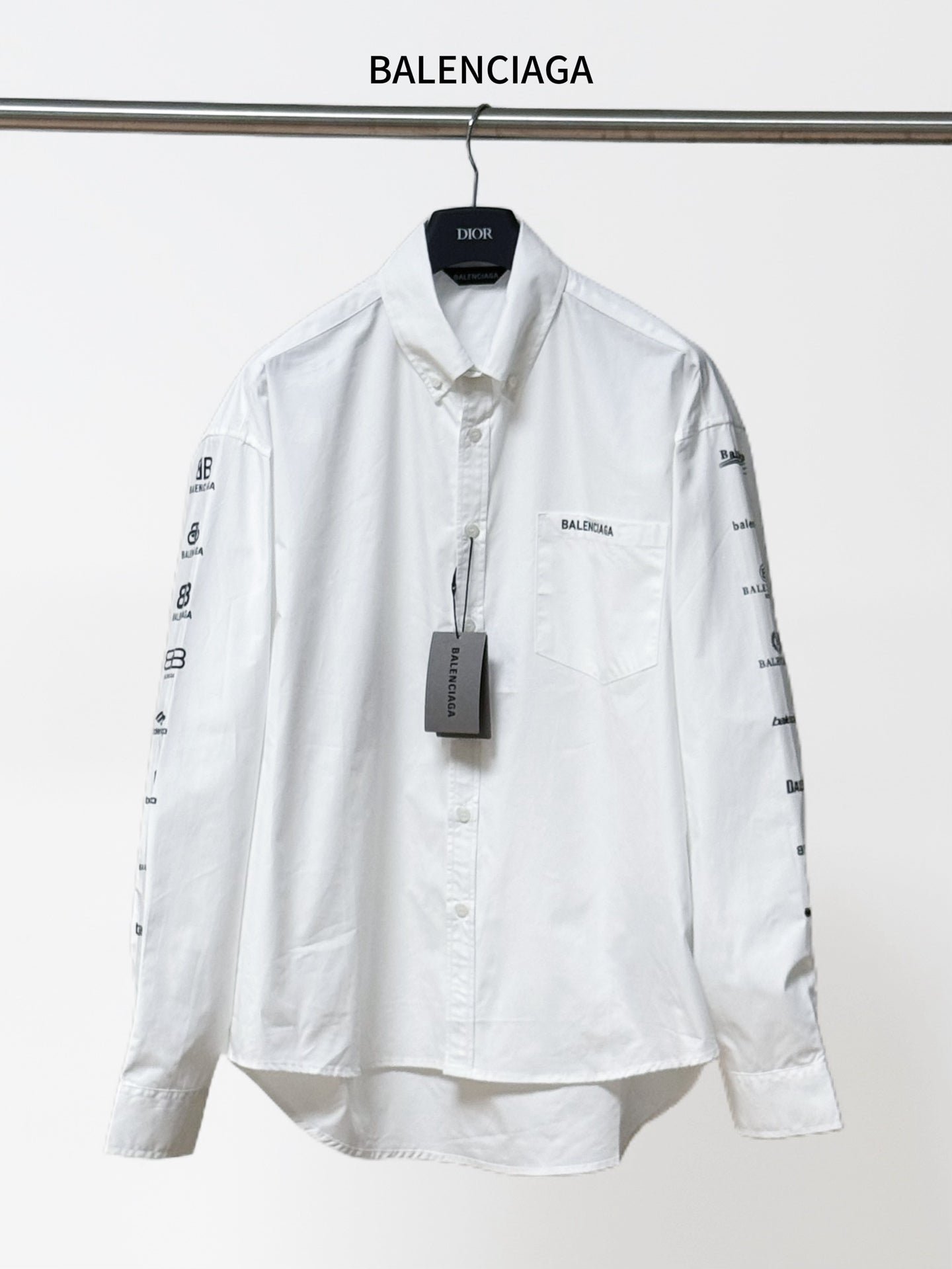 White Balenciaga long-sleeve button-up shirt with front pocket and logo sleeve prints