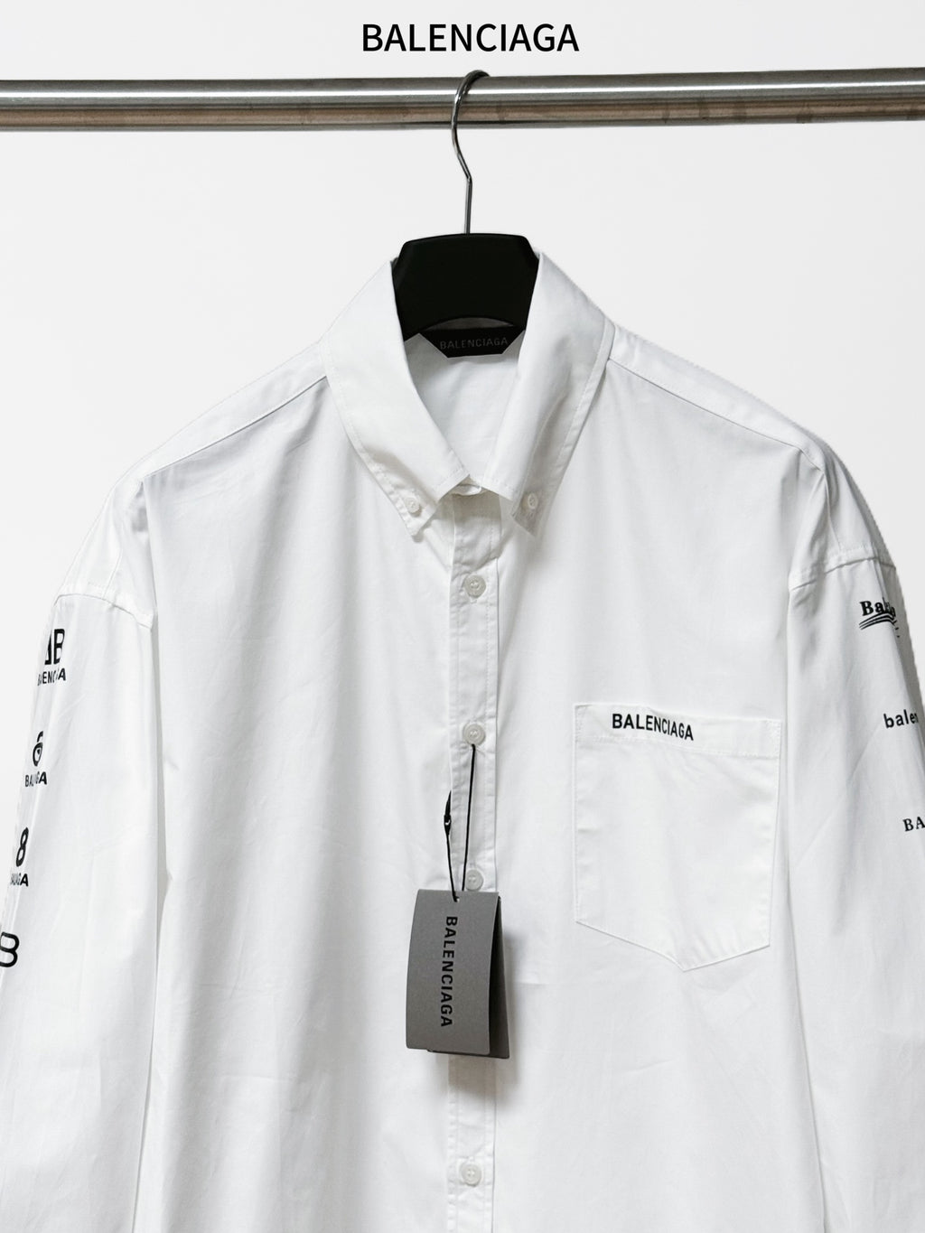 White Balenciaga button-up shirt with chest pocket and logo tag at center front