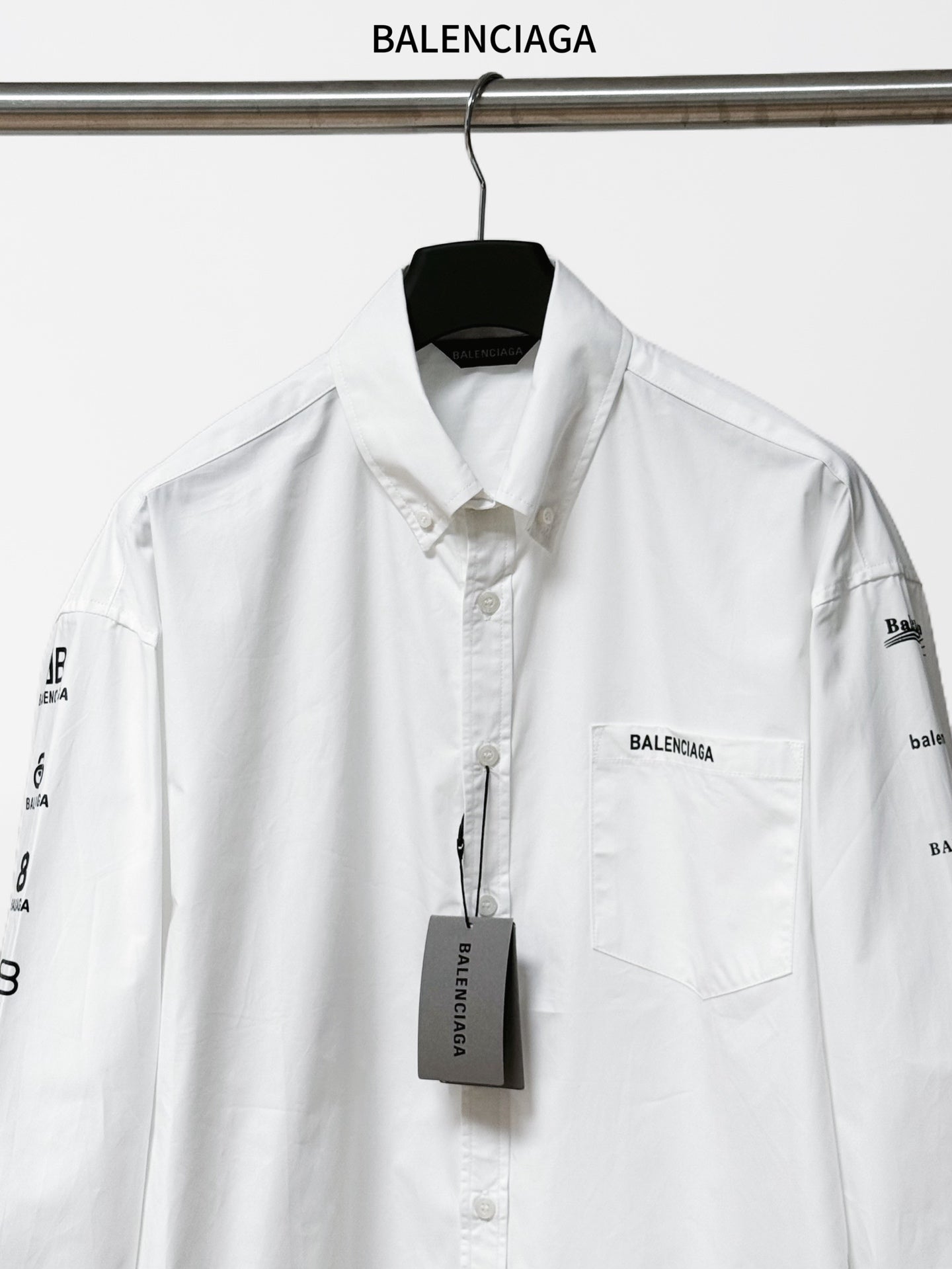 White Balenciaga button-up shirt with chest pocket and logo tag at center front