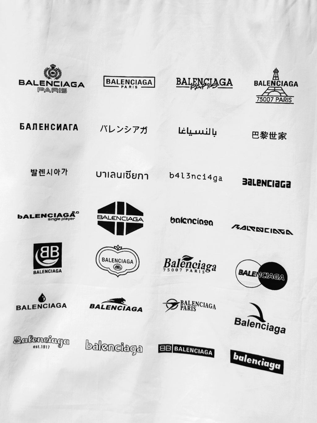 Balenciaga logo print fabric with multiple black emblems and wordmarks