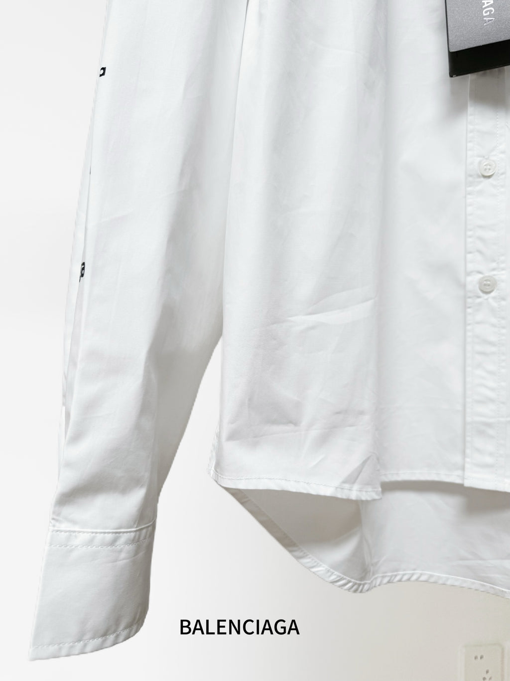 White Balenciaga long-sleeve shirt with side hem detail and buttoned cuff