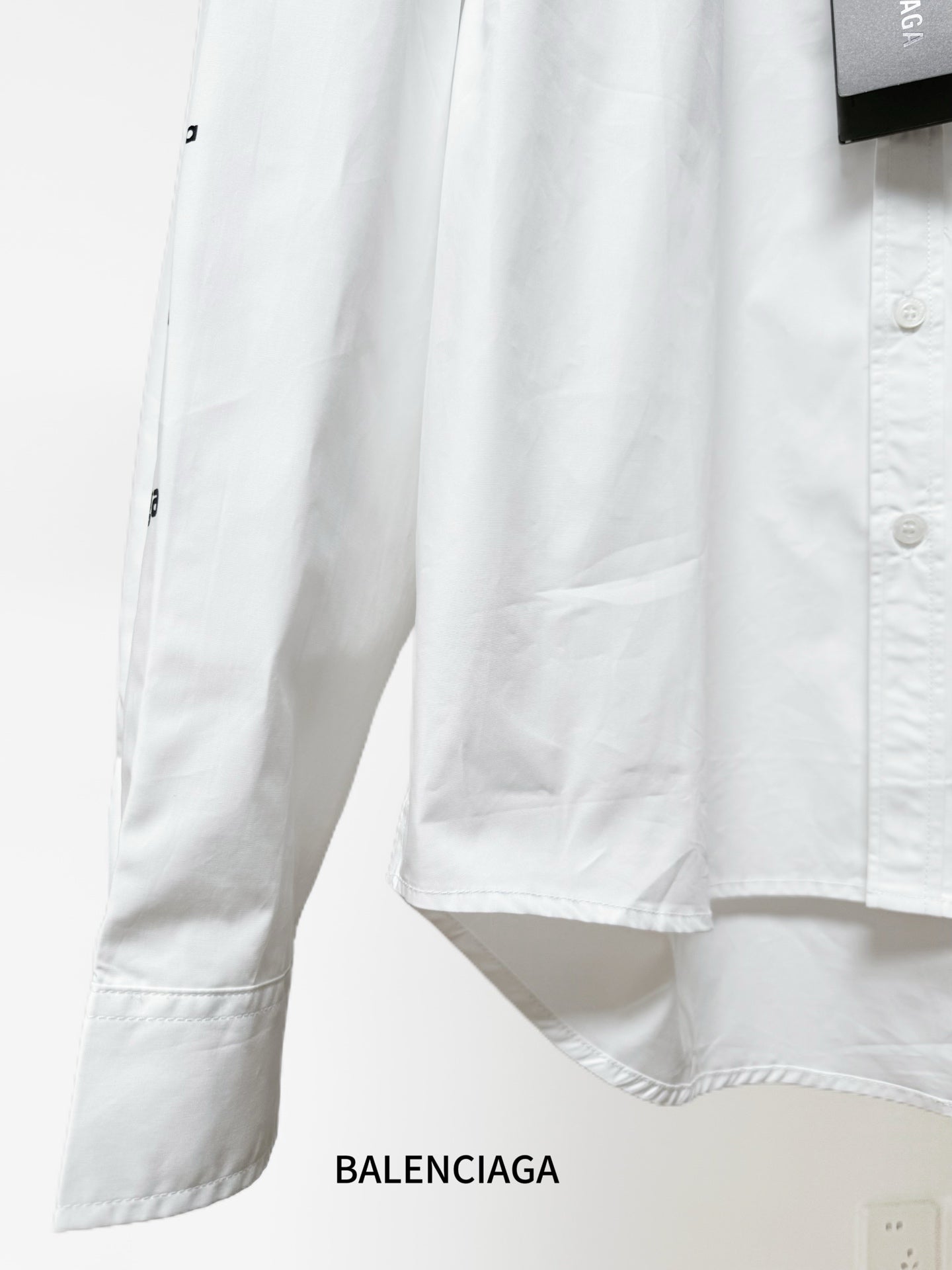 White Balenciaga long-sleeve shirt with side hem detail and buttoned cuff