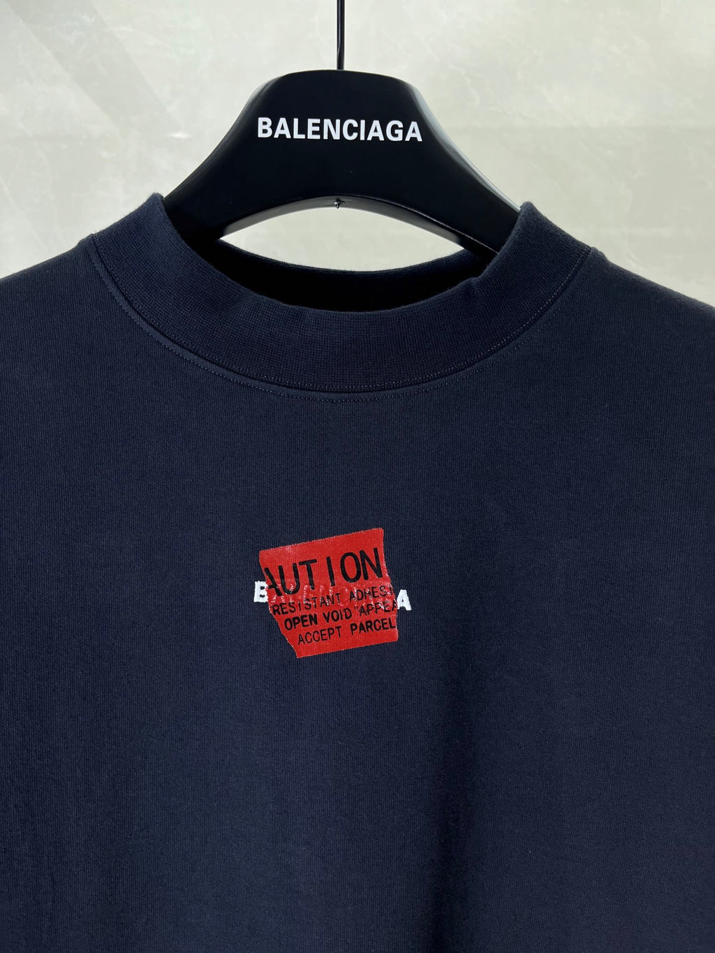 Navy crewneck T-shirt with red square graphic print at the chest