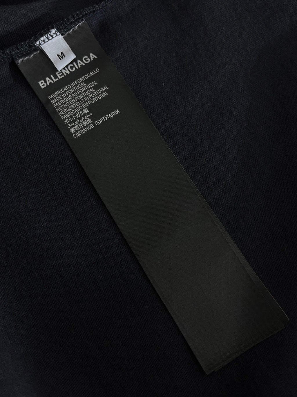 Navy T-shirt with internal neck label and size “M” marking