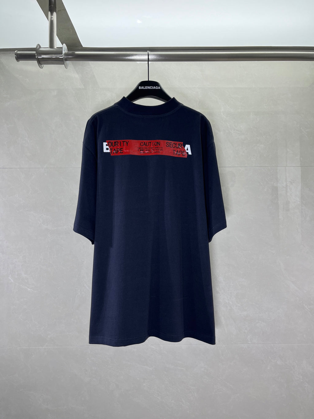 Navy short-sleeve T-shirt with wide red graphic text band across back
