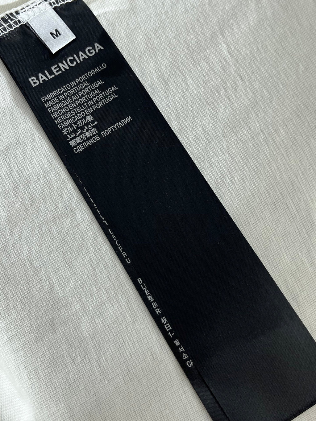 Balenciaga T-shirt size tag on inner seam, black label with white text