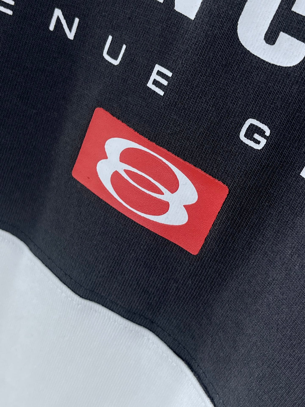 Balenciaga logo patch detail on dark T-shirt fabric