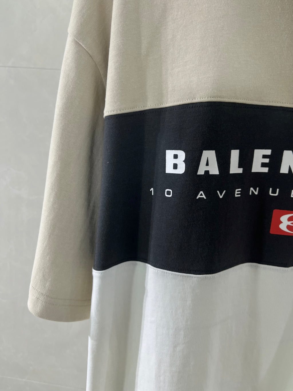 Balenciaga logo T-shirt detail, black band with BALENCIAGA text and red icon
