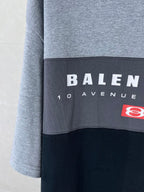Two-tone T-shirt panel close-up with BALENCIAGA text and red logo patch