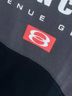 BALENCIAGA red emblem patch on dark T-shirt fabric