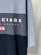 Two-tone T-shirt sleeve close-up with BALENCIAGA lettering and red logo