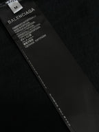 Black garment label with BALENCIAGA text and care instructions
