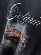 Navy T-shirt chest close-up of Getaria cursive with EUSKADI beneath.