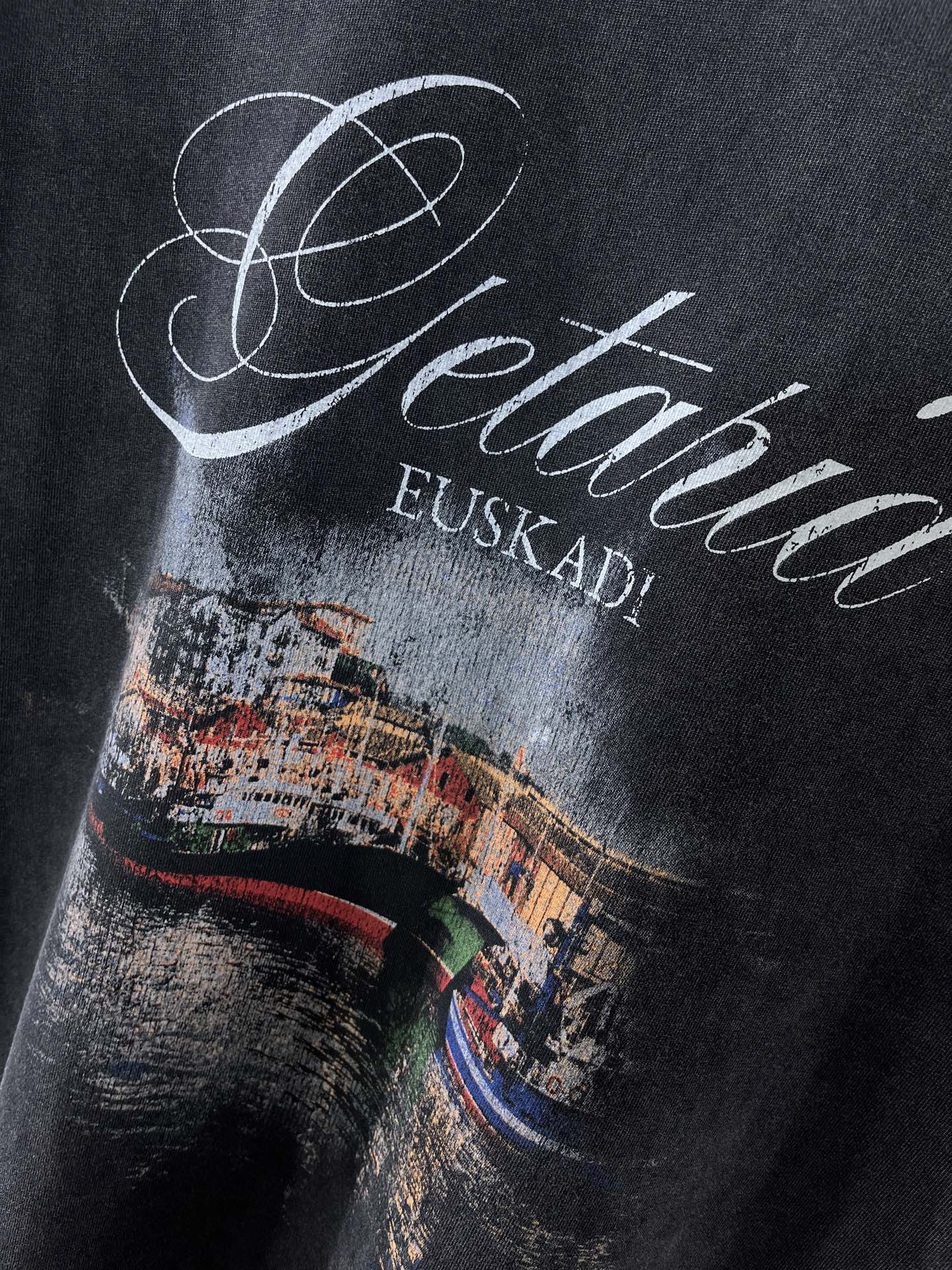 Navy T-shirt chest close-up of Getaria cursive with EUSKADI beneath.