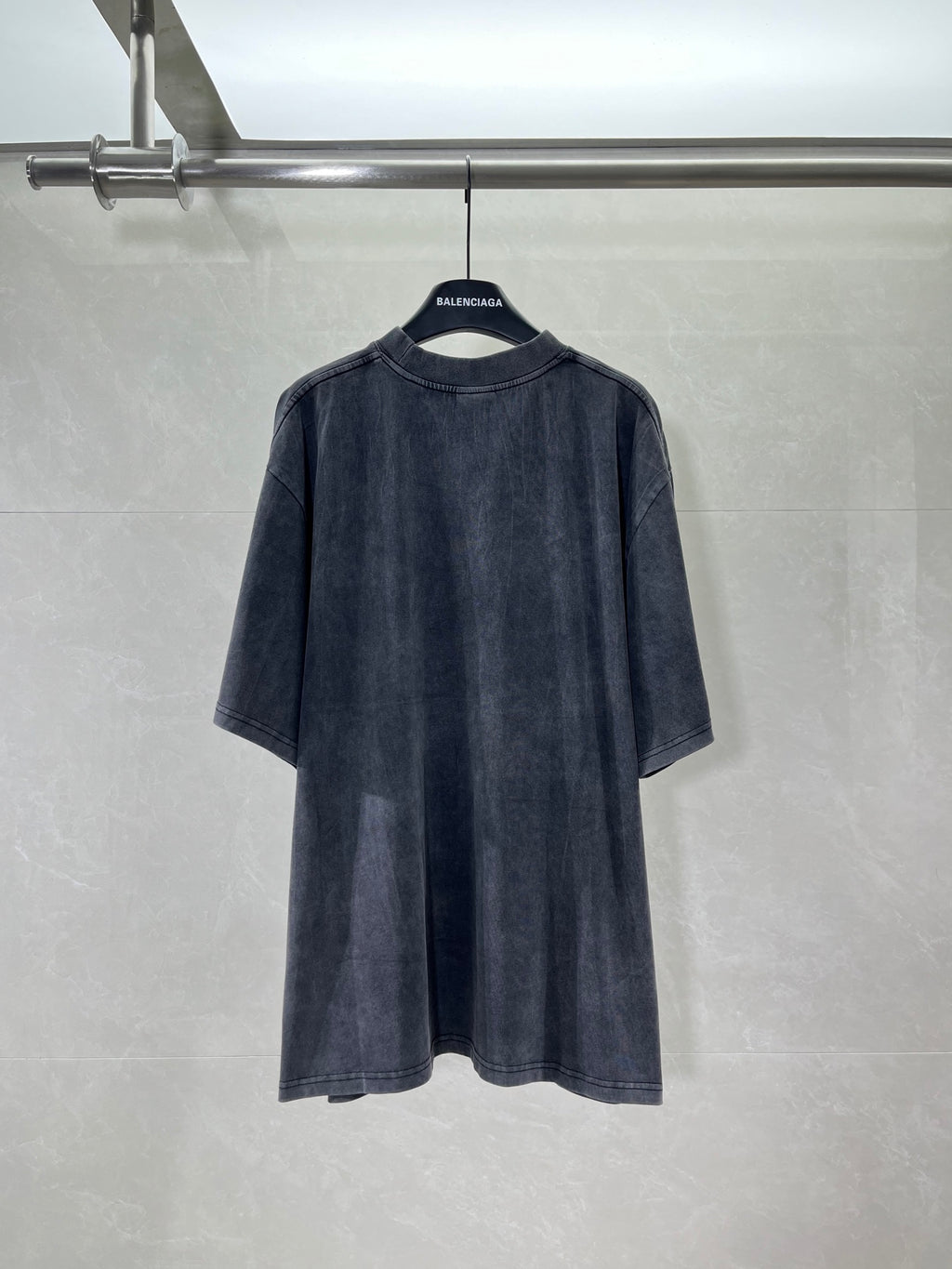Navy crewneck T-shirt, back view, long graphic print across upper back.