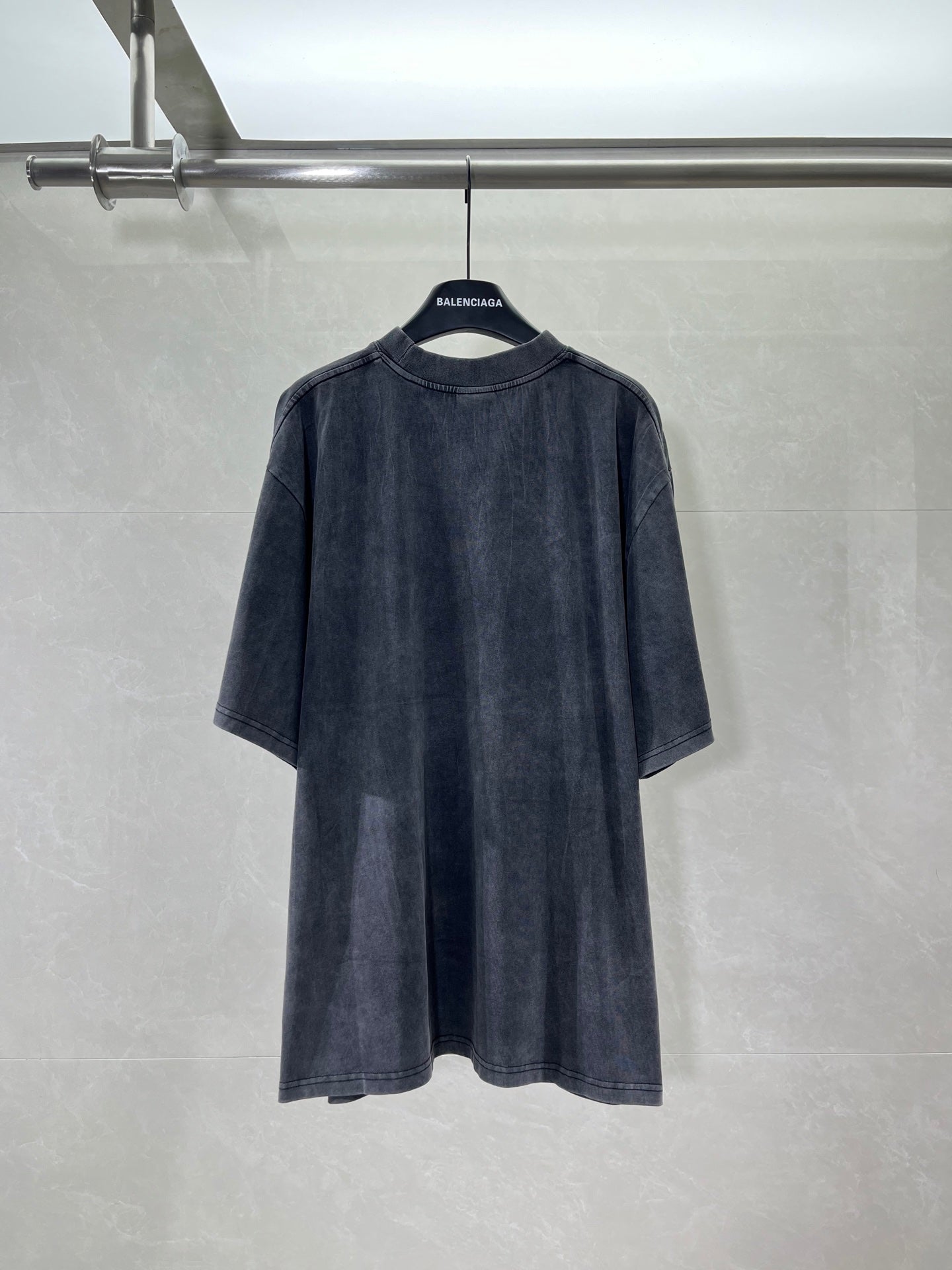 Navy crewneck T-shirt, back view, long graphic print across upper back.
