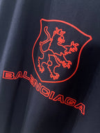 Navy Balenciaga T-shirt close-up of red shield lion graphic and lettering