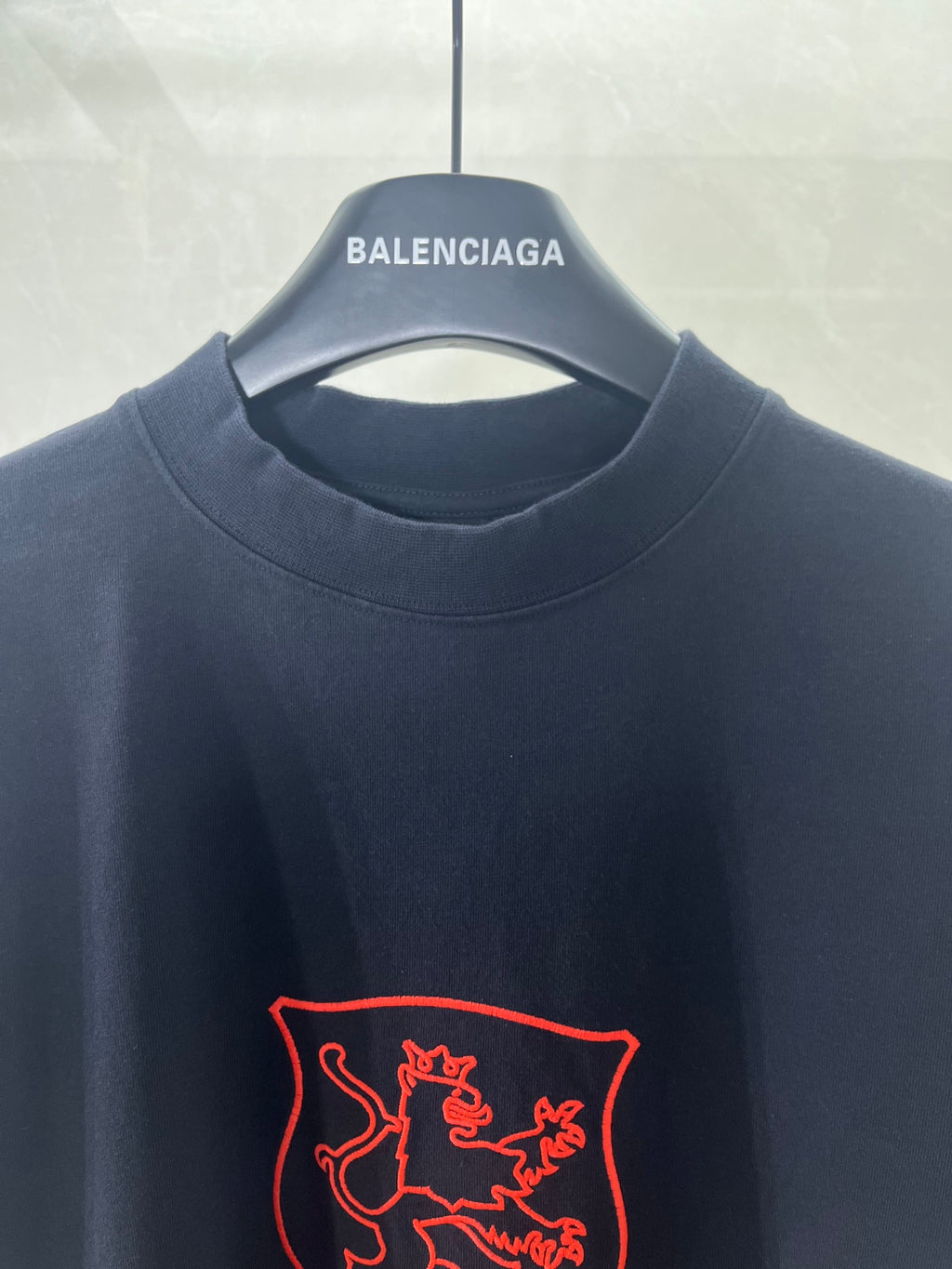 Navy Balenciaga T-shirt close-up of crew neck and red shield logo