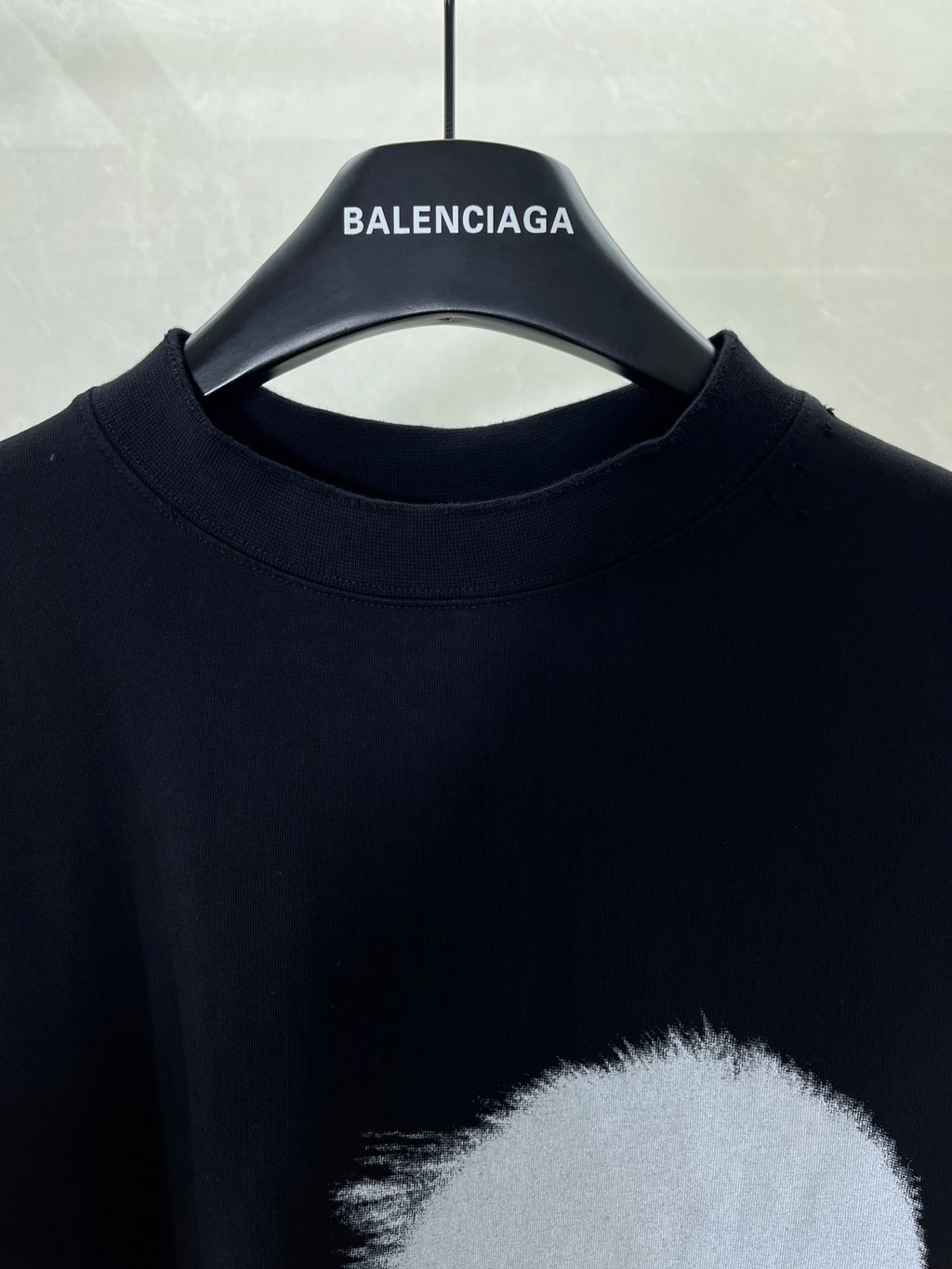 Black short-sleeve T-shirt with crew neckline and large face print