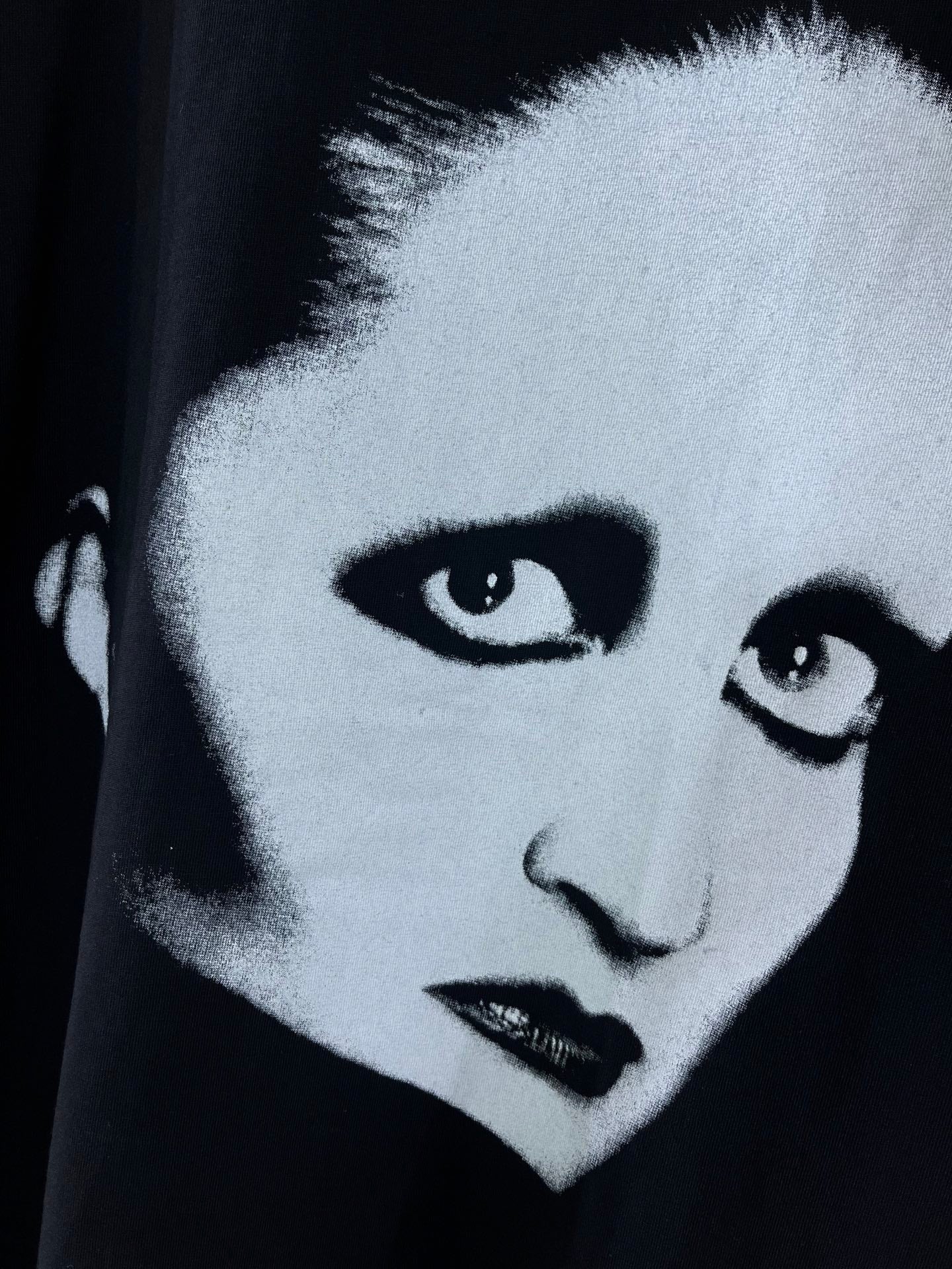 Black short-sleeve T-shirt with close-up white face and dark lips graphic