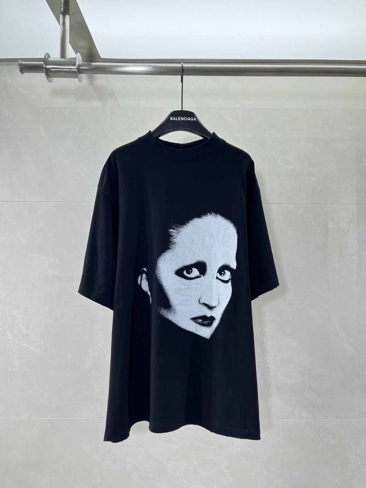 Black short-sleeve T-shirt with large face graphic front