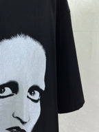 Black short-sleeve T-shirt with close-up of white face eyes graphic