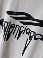 Balenciaga logo T-shirt close-up of black drip lettering print on light gray