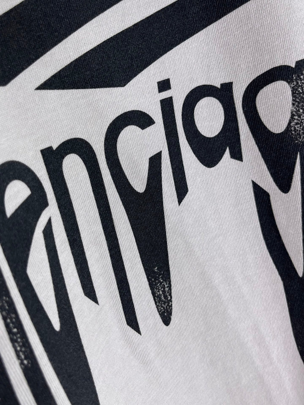 Balenciaga logo T-shirt close-up of black lettering print on light gray