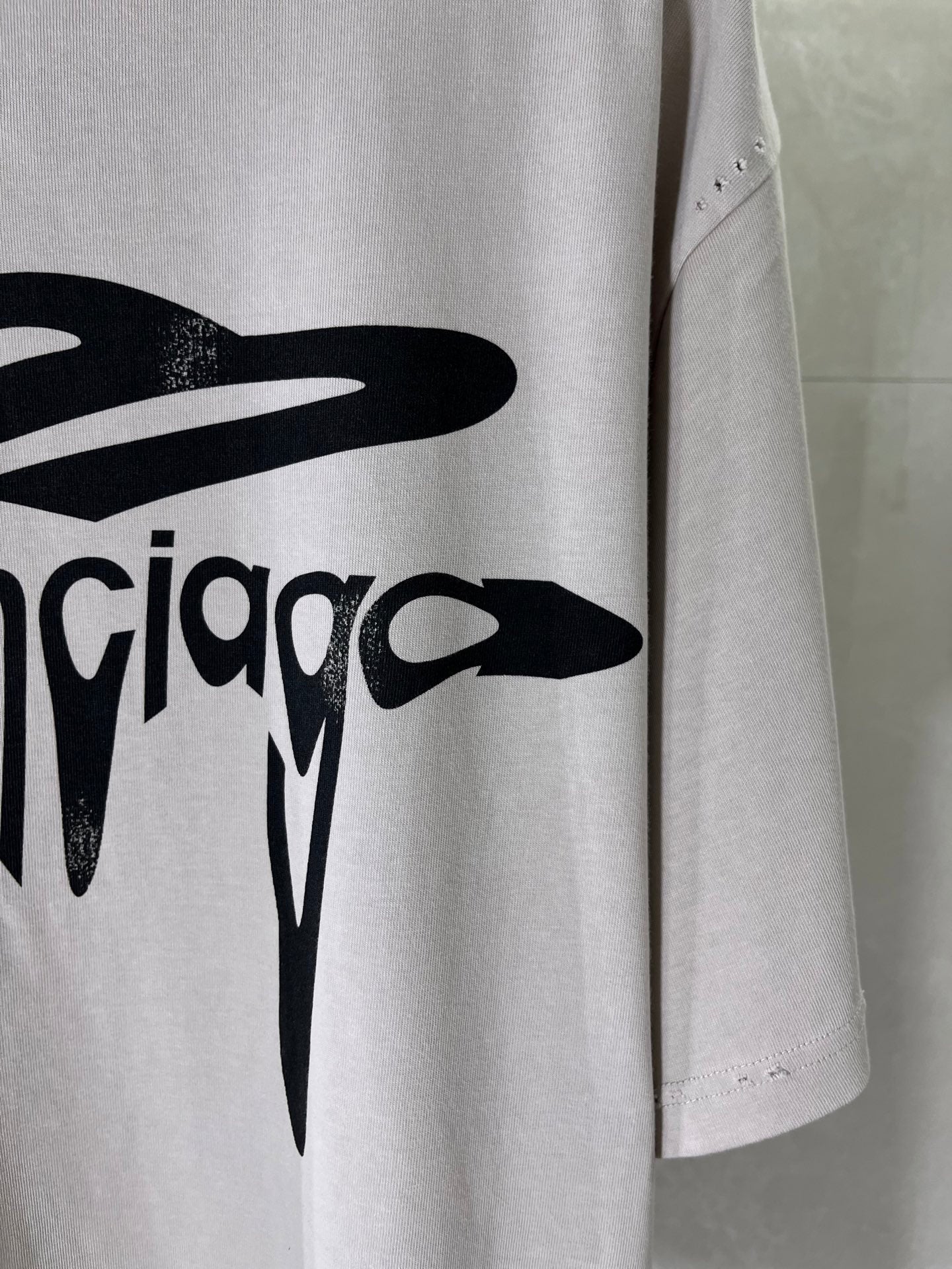 Balenciaga logo T-shirt front print and side view, light gray with black graphic