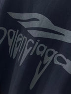 Navy Balenciaga T-shirt front logo graphic close-up with partial lettering.