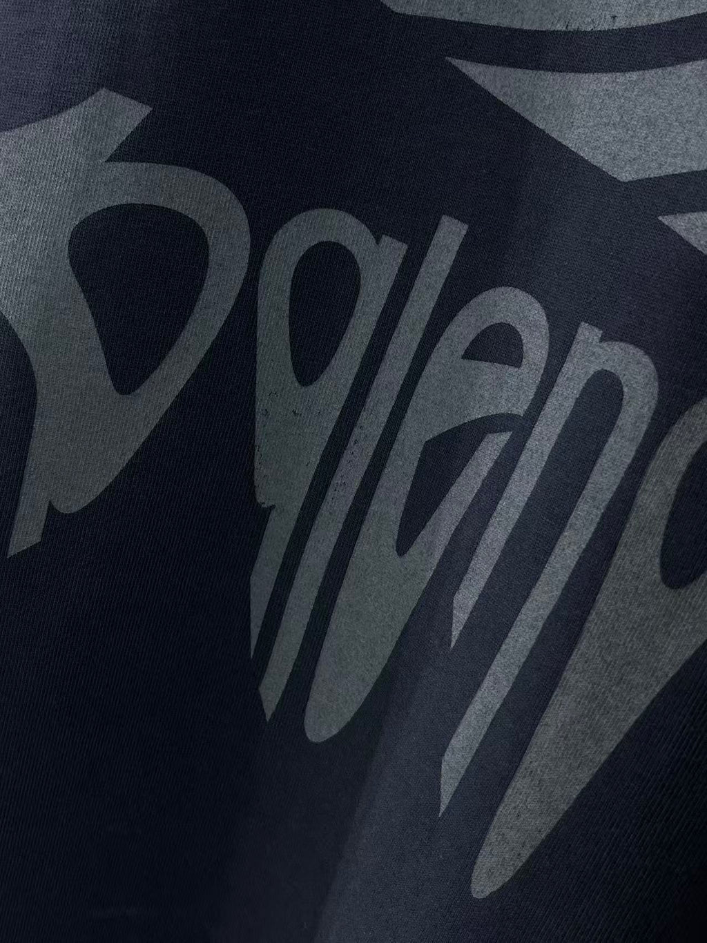 Navy Balenciaga T-shirt front logo graphic lettering close-up.