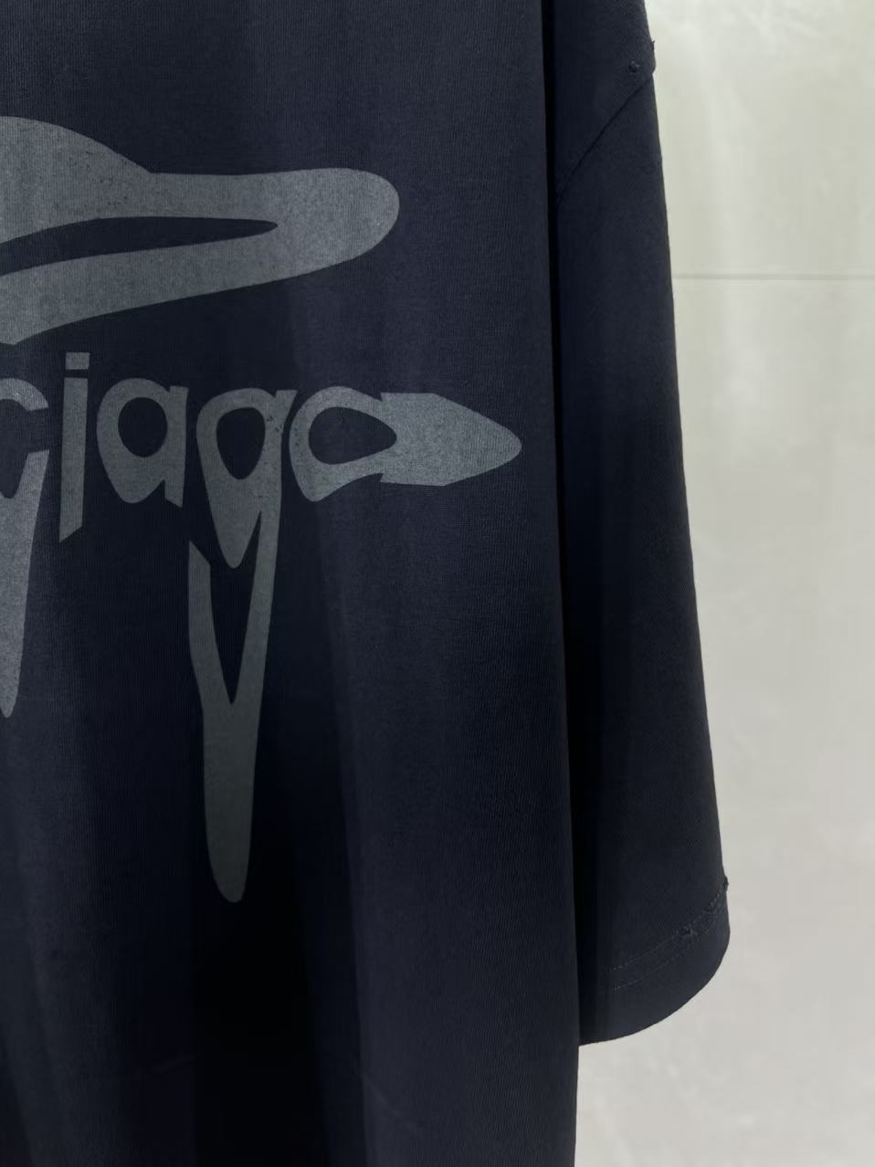 Navy Balenciaga T-shirt side view with front logo graphic detail.