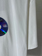 White Balenciaga T-shirt showing hemline and part of the colorful disc graphic