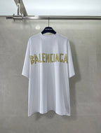 White Balenciaga T-shirt with large yellow BALENCIAGA graphic across chest
