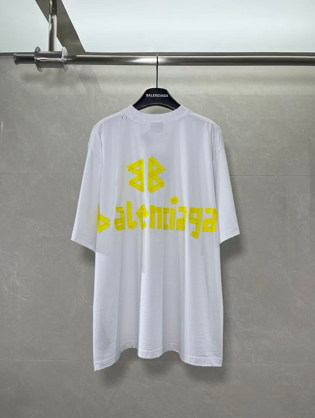 White Balenciaga T-shirt with yellow AB and Balenciaga text graphic on chest