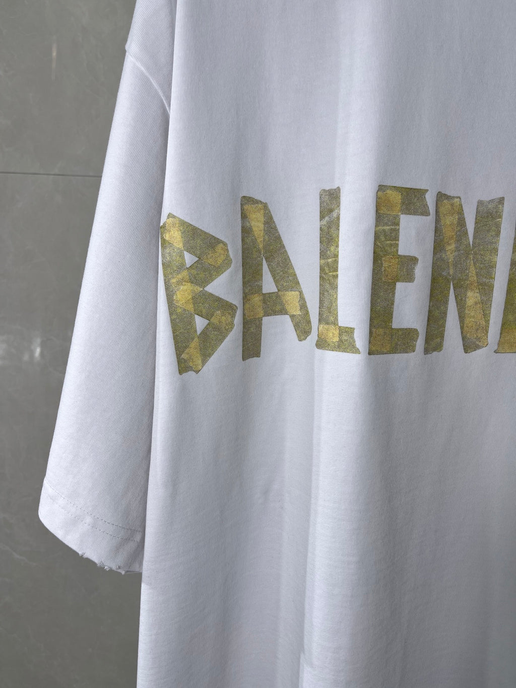 White crewneck Balenciaga T-shirt sleeve and chest graphic in gold lettering